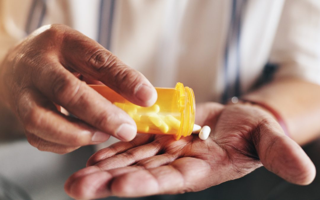 Hands, pills and bottle in closeup for person with drugs, routine and schedule for health in home. Elderly patient, container and pharma product for supplements, wellness or benefits in retirement